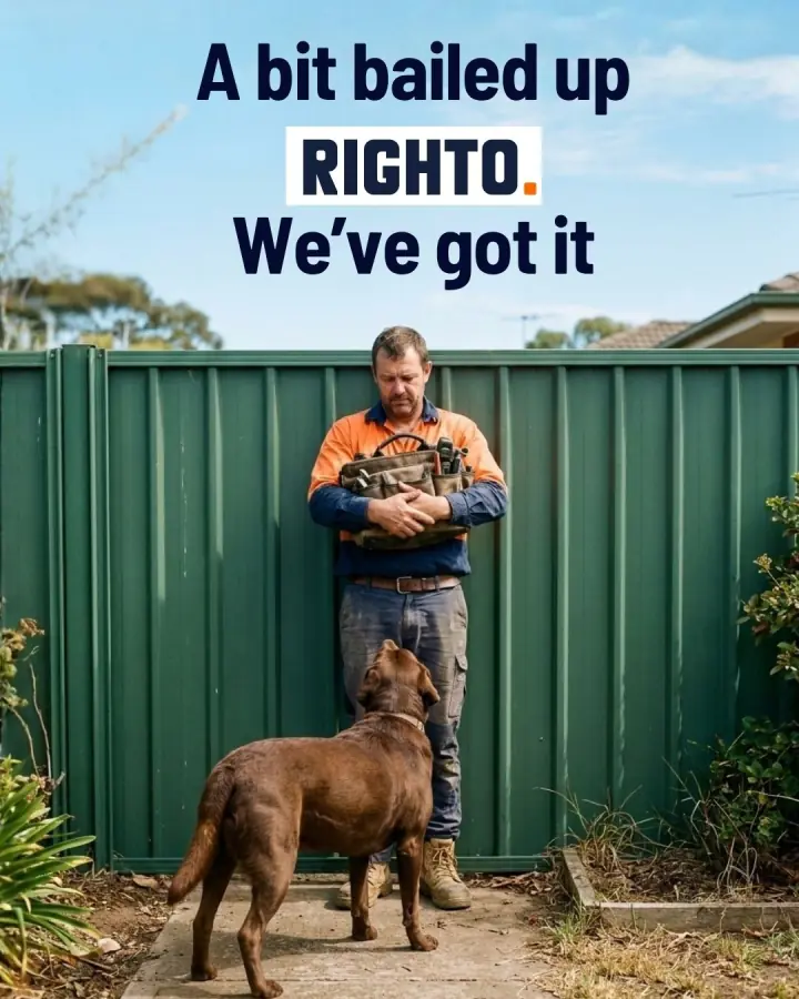 Tradie waiting by a fence while a dog blocks the way