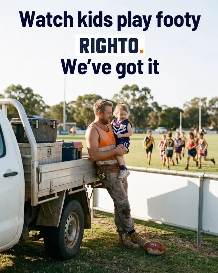 Tradie watching the kids play footy from the sideline